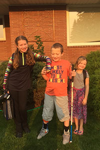 Eddie and his sisters posing in the front yard