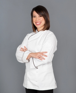 Christina Ha standing with arms folded wearing a white chef's tunic and black pants; Courtesy of Julie Soefer Photography
