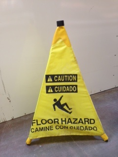 yellow sign warning of floor hazard