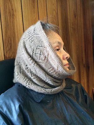grey scarf wrapped around woman's neck and head