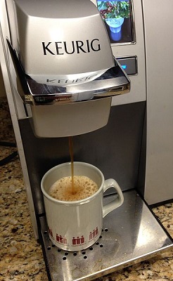 keurig machine with cup on base