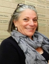 Pauline Winick, dressed fashionably with scarf around neck