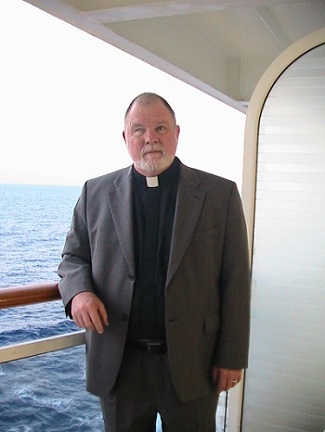 Father Warnke, standing near boat railing