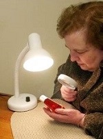 reading with a flexible-arm desk lamp