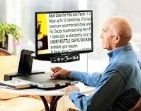 older man using a video magnifer to read