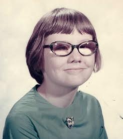 Sheila as child wearing thick glasses