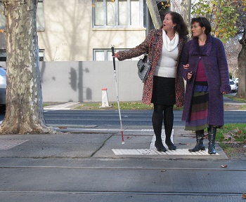 maribel getting help from sighted person in crossing street