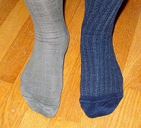 man wearing one brown and one blue sock