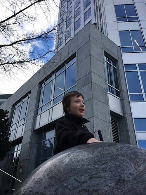 Eddie in front of a striking high-rise building