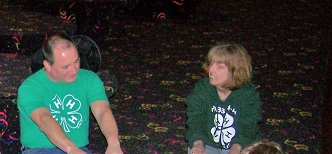 Trina and husband wearing 4-H shirts at roller skating event