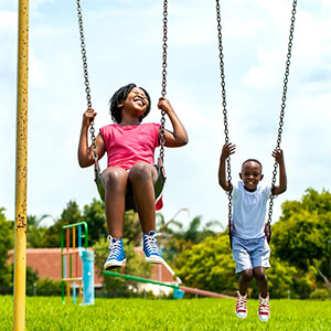 Kids having fun swinging in park