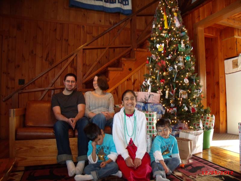 Susan Harper's children sitting by Christmas Tree