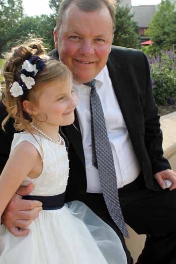 Dave and Mary Rose in white dress with flowers in her     hair