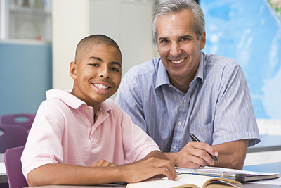 Teacher giving personal instruction to male student