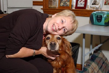 Detra and her guide dog Yulea at work posing for the camera