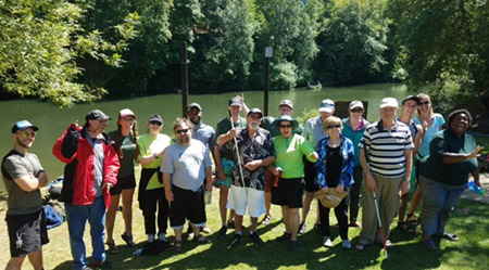 Audrey and her group at Hull Park standing in front of a river taking a group photo