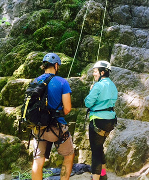 Audrey and her instructor talking before Audrey started her climb up the mountain