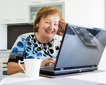 Older woman working on a laptop computer