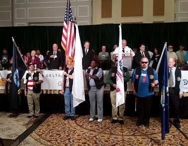 Color guard with veterans holding different flags Joe Hobson on far right