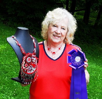 Lynda holding my bleeding heart talisman and blue ribbon