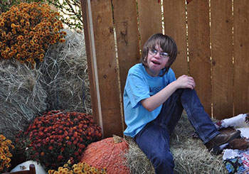 JD at age 11 sitting on a haybail