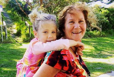 Maribel with granddaughter playing piggyback