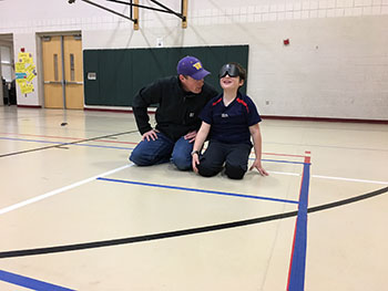 Eddie and his father playing goalball 