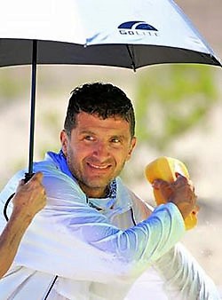Jason Romero under an umbrella during a race