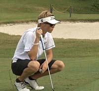 Jake lining up a put while golfing