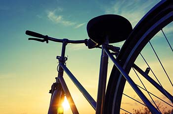 silhouette of a bicycle against a sunset