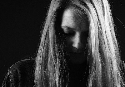 woman sitting with head down