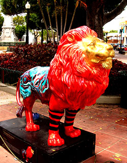 Statue of a colorful lion with red socks 