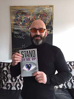 Dave Steele holding his book, Stand with Me RP