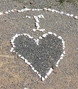 Pebbles on the ground in a heart shape