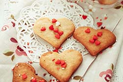 Heart-shaped cookies with red heart sprinkles