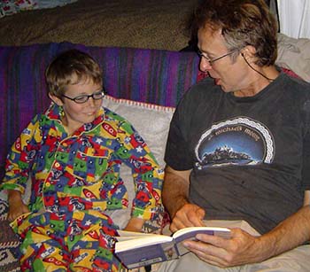 a man (Harry) reading a book to his step-son (Michael)