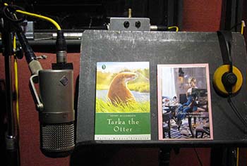 A stand with a children's book and microphone prepared to an audiobook recording 