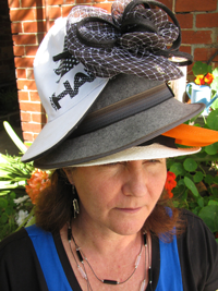 Maribel Steel wearing many different hats atop her head.