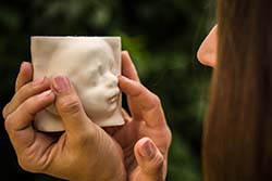 A picture of a woman holding a 3D mold of her child's ultrasound