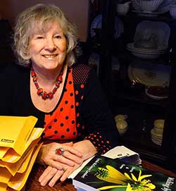 Lynda sitting at a desk with books