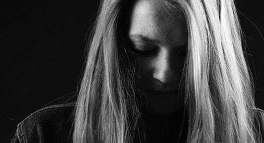 black and white photo of a woman looking down