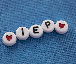 White beads with the acronym IEP for individualized education program