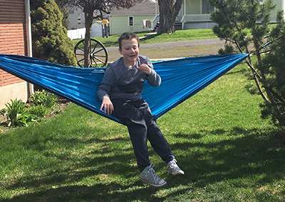 Eddie outside sitting in a hammock