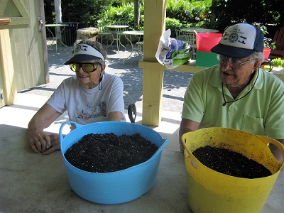 two boothbay support group members with pots in front