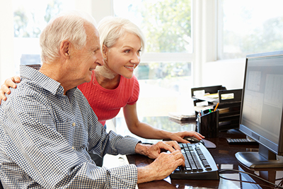 Senior man and daughter using a computer