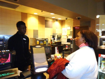 woman ordering popcorn at movie concession stand