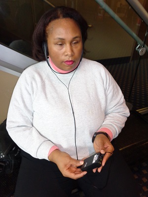 woman using headset to access audio description