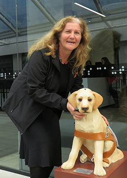 woman standing in window with hand on dog