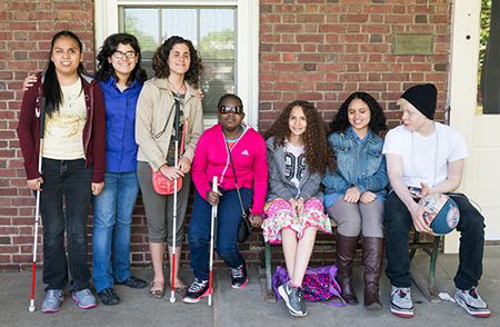  A group of high school age students lined up to take a class picture