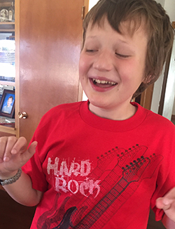 Eddie in a bright red shirt smiling at the camera